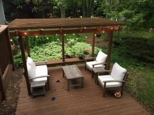 BEFORE - colorful outdoor space makeover using thrifted furniture, globe lights, and vivid pillows