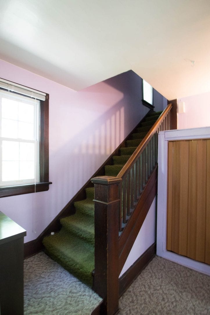 stairs going upstairs, dark wood green carpet